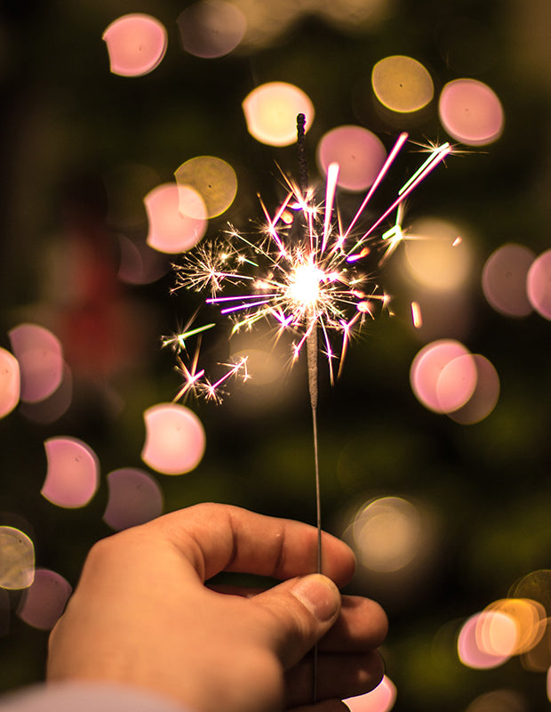 hand holding pink sparkler