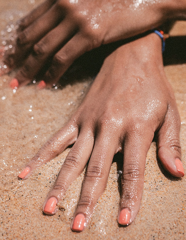manicured nails on a sandy beach