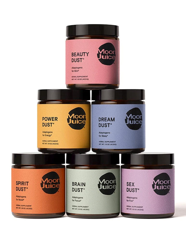 Moon Juice product pots stacked in a pyramid on a white background