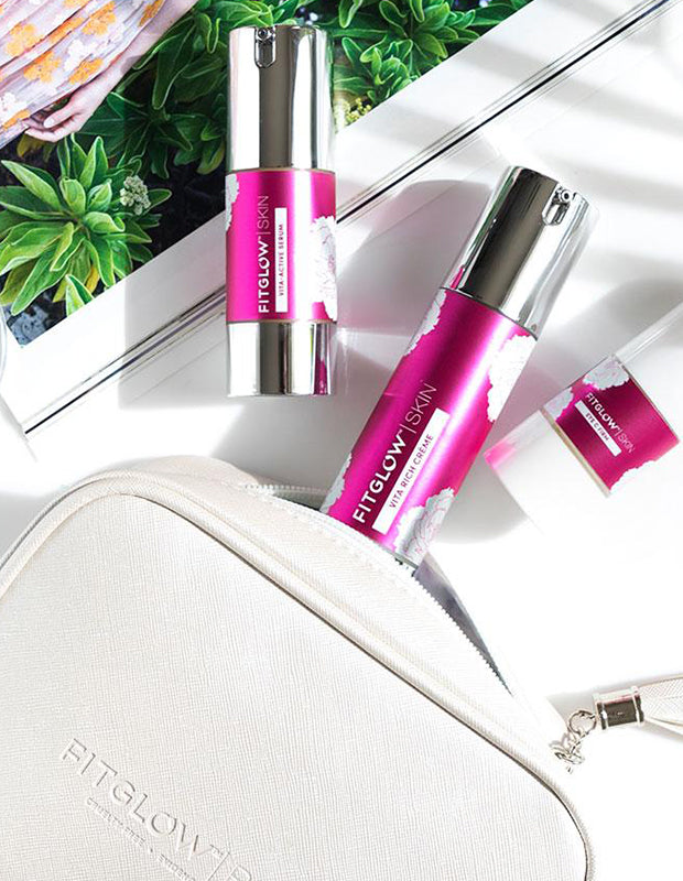 Fitglow products and bag on a tabletop with a travel magazine